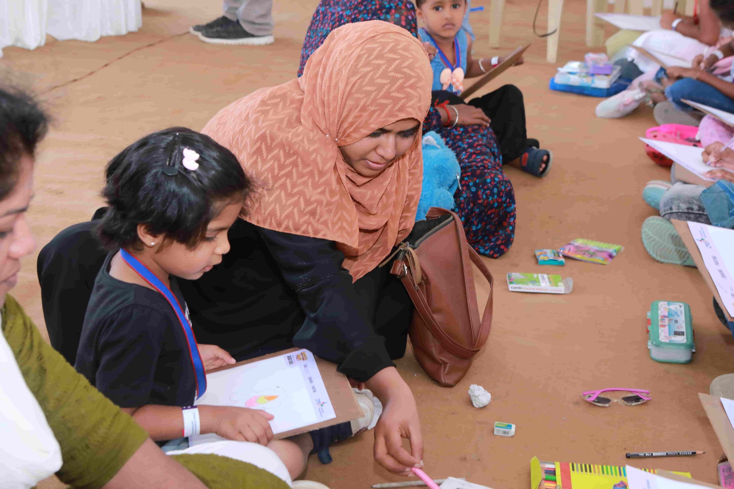 Parents helping their kids in a drawing activity.
