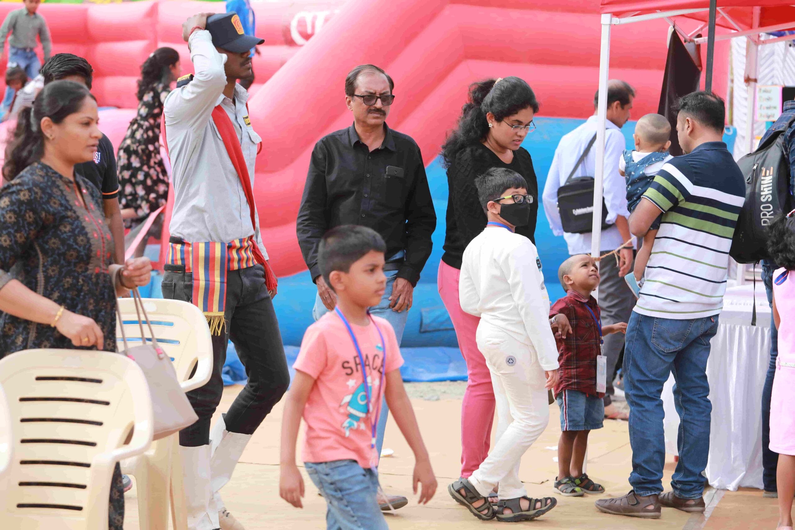 Image of parents and children walking around in the fest.
