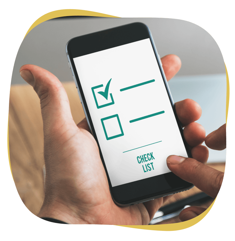 Image of a person holding a smart phone displaying a checklist.