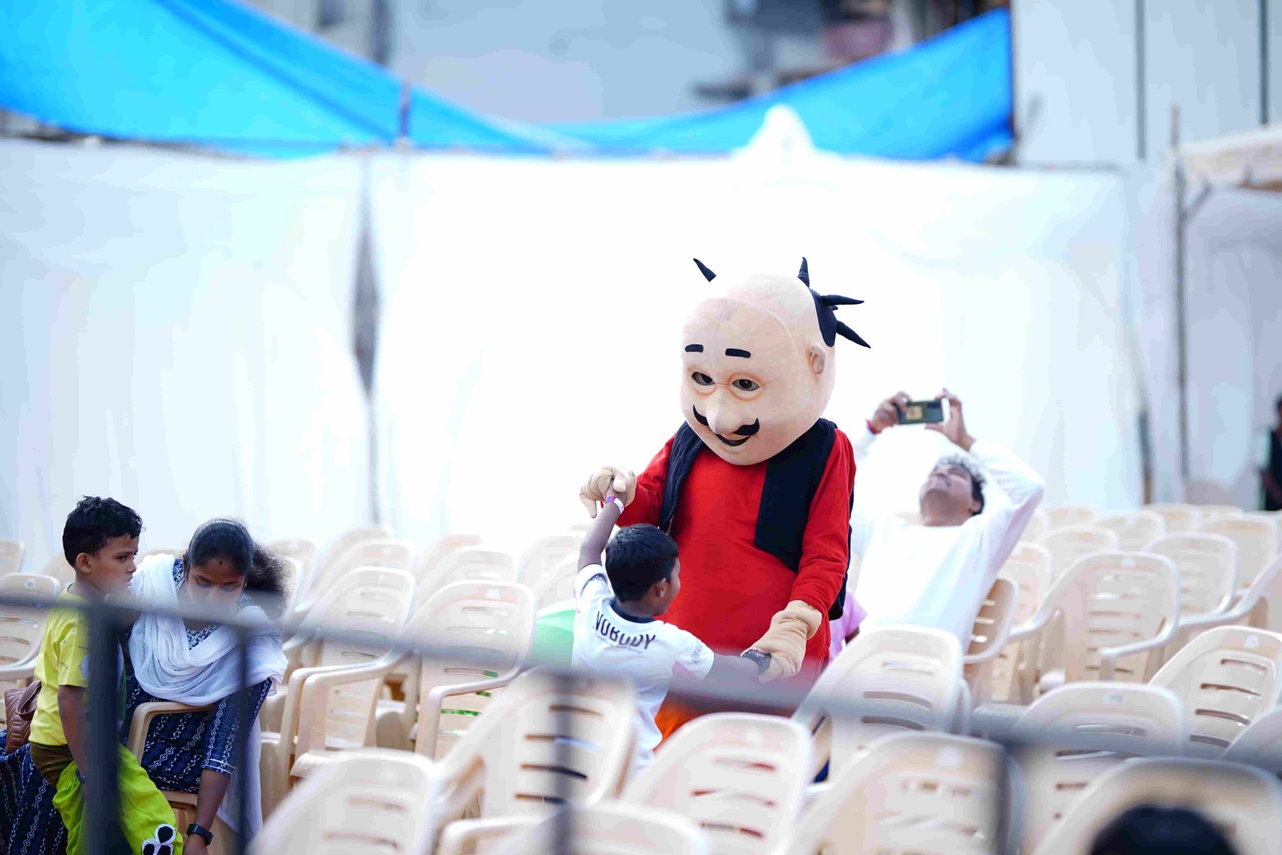 A boy dancing happily with Motu character actor.