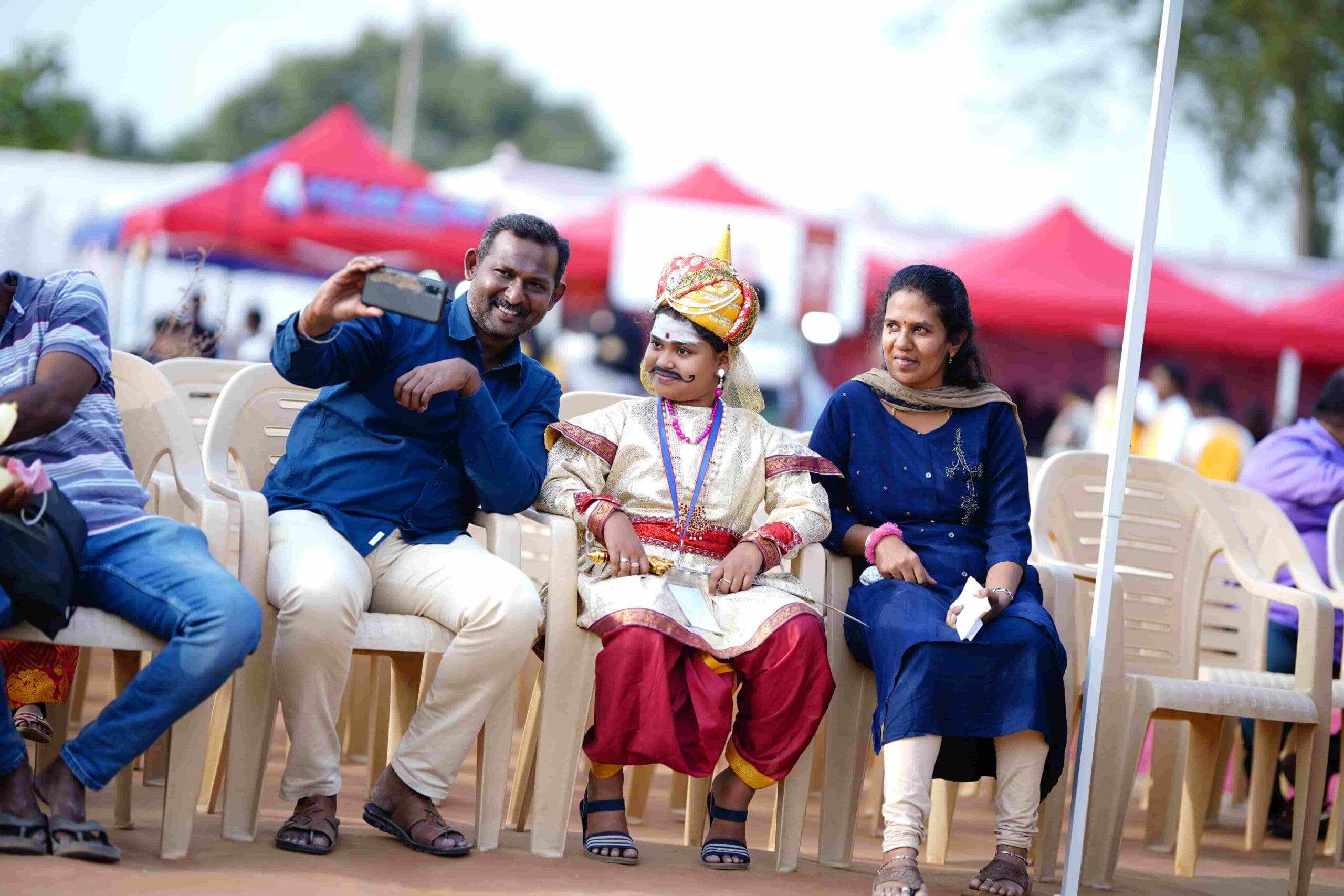 Happy parents posing for a selfie with their child in costume at the fest.