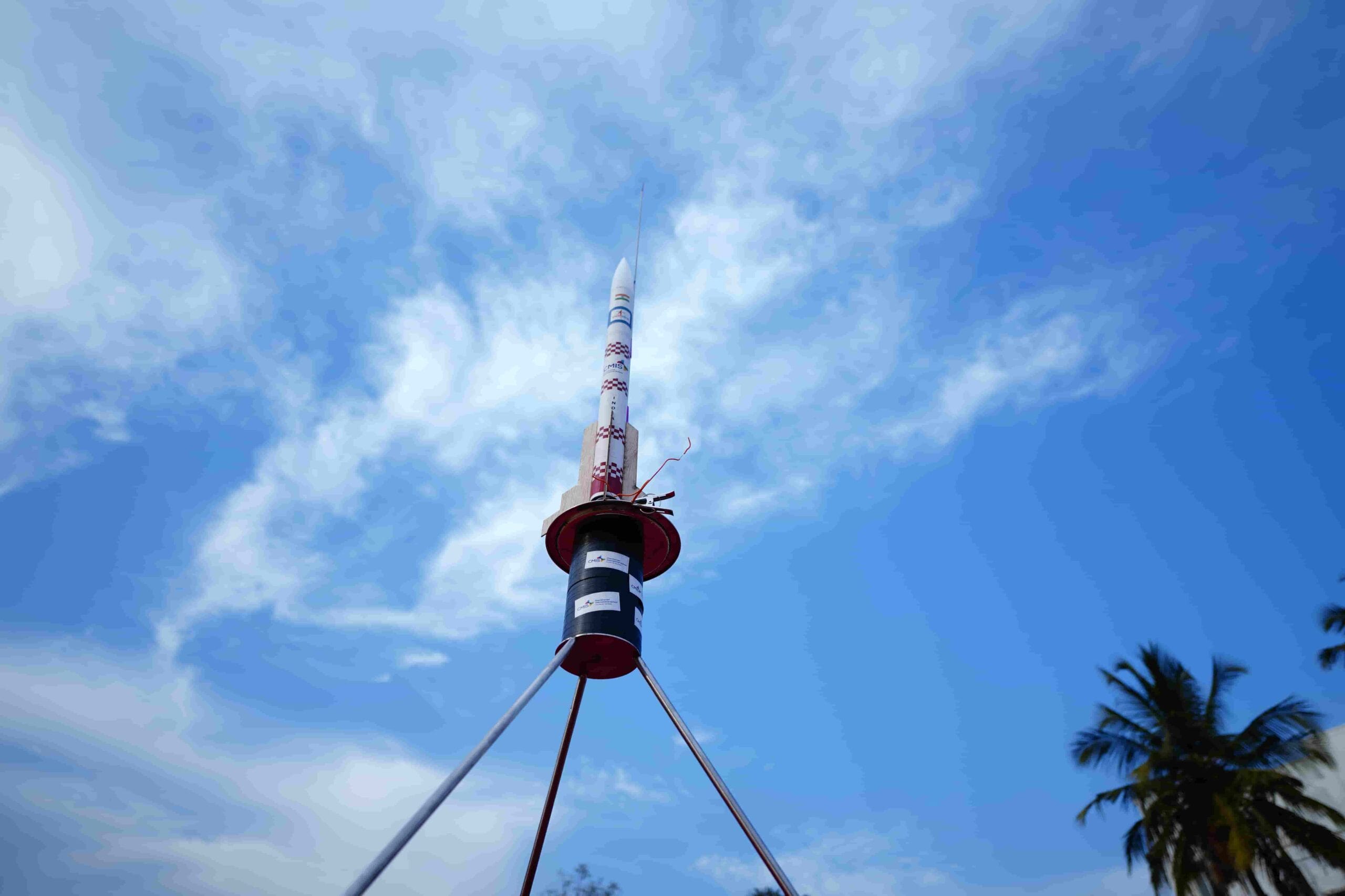 A rocket model with blue sky in the launch pad complex.
