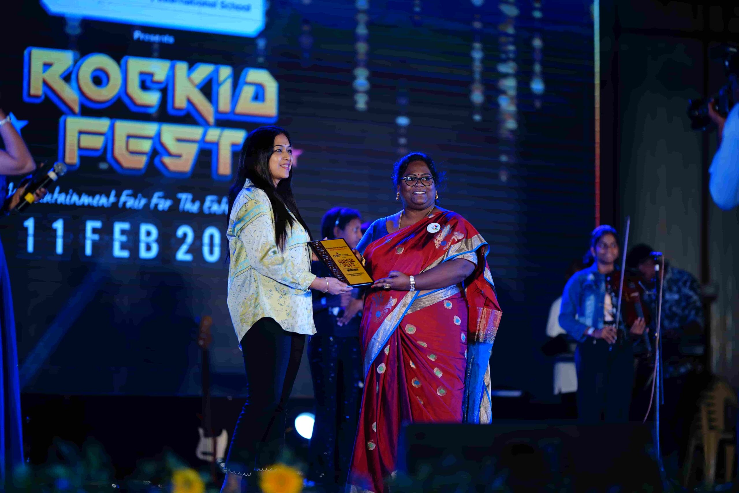 The Staff of CMIS honour the chief guest of Rockid Fest with a shield.