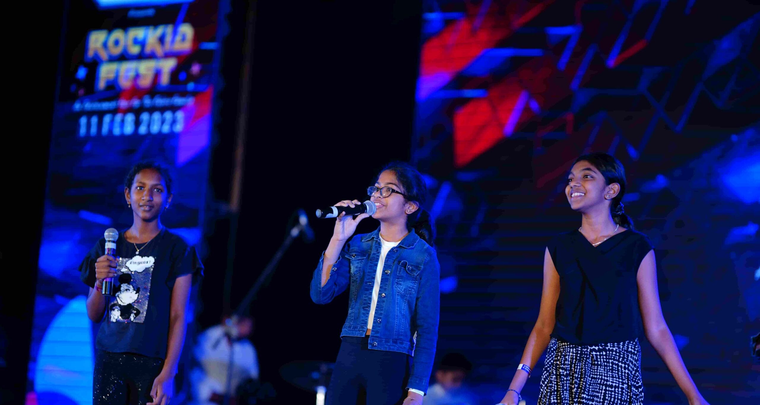 Image of Chandramari International School students giving a singing performance on stage.