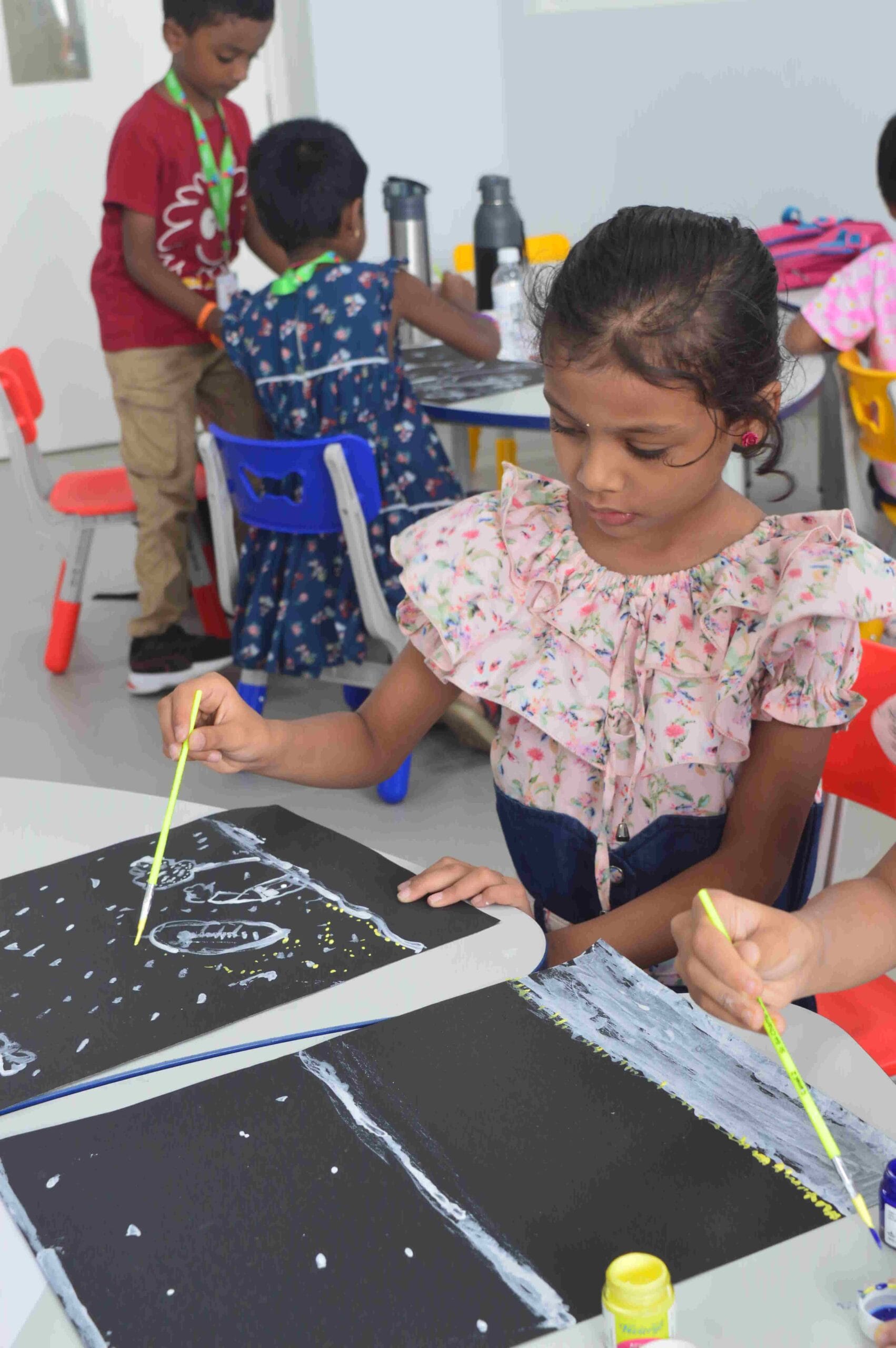 Student painting in the black chart.