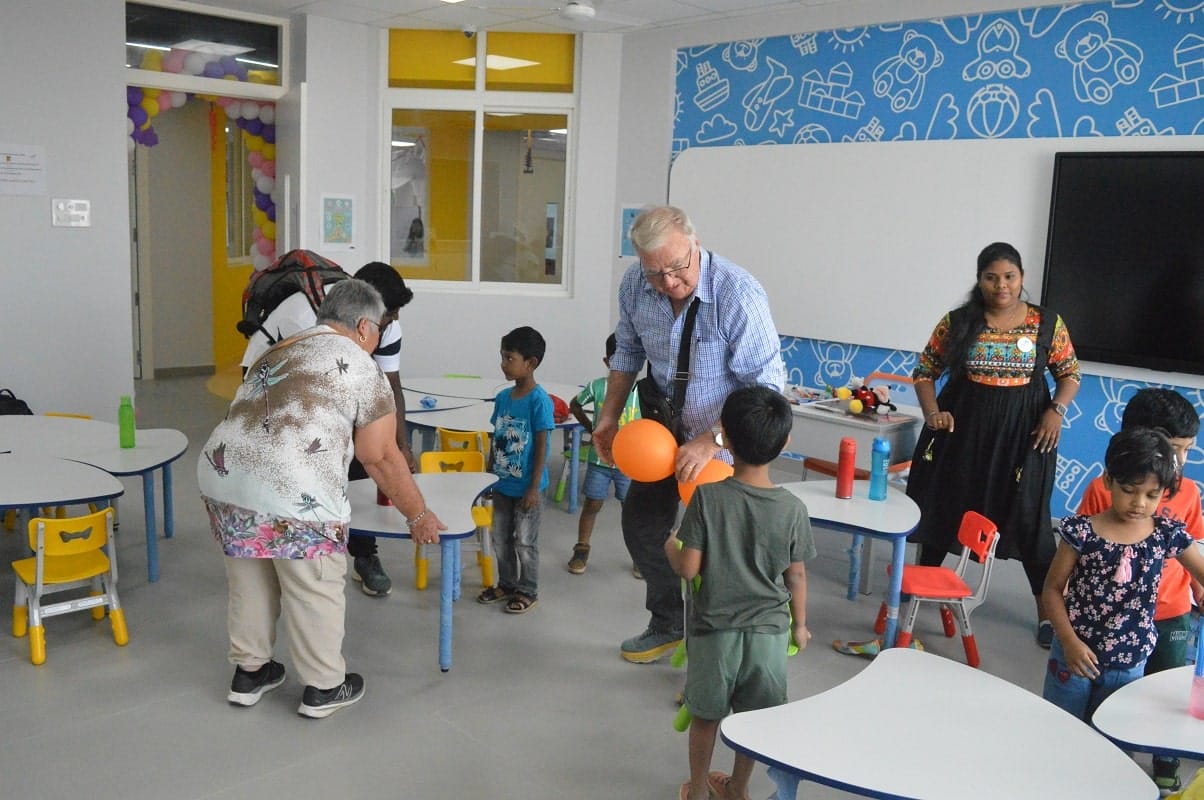 Staff and teachers interact with the students.