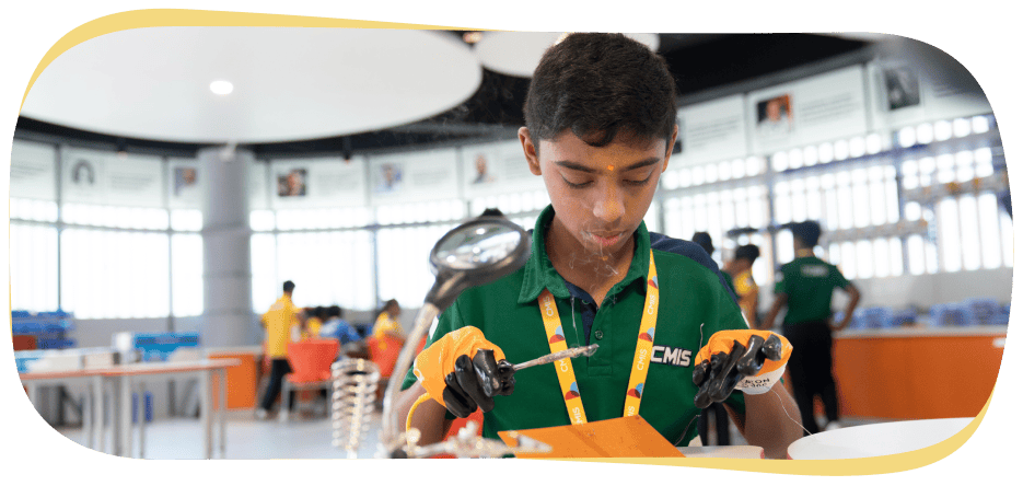 A CMIS student working in a lab with a soldering rod.