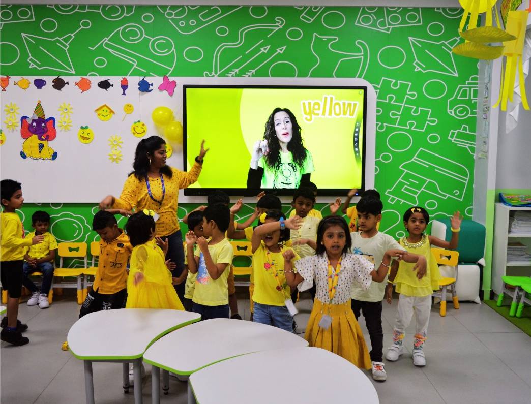 Students and teachers joyfully dancing together on sunshine day
