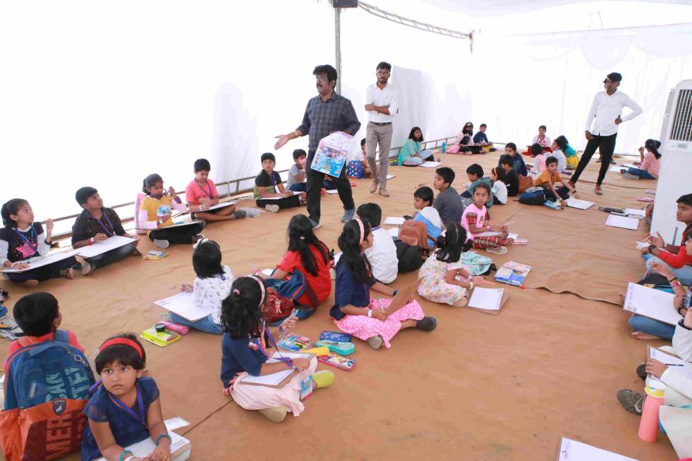 Instructors monitoring the children in the drawing competition.