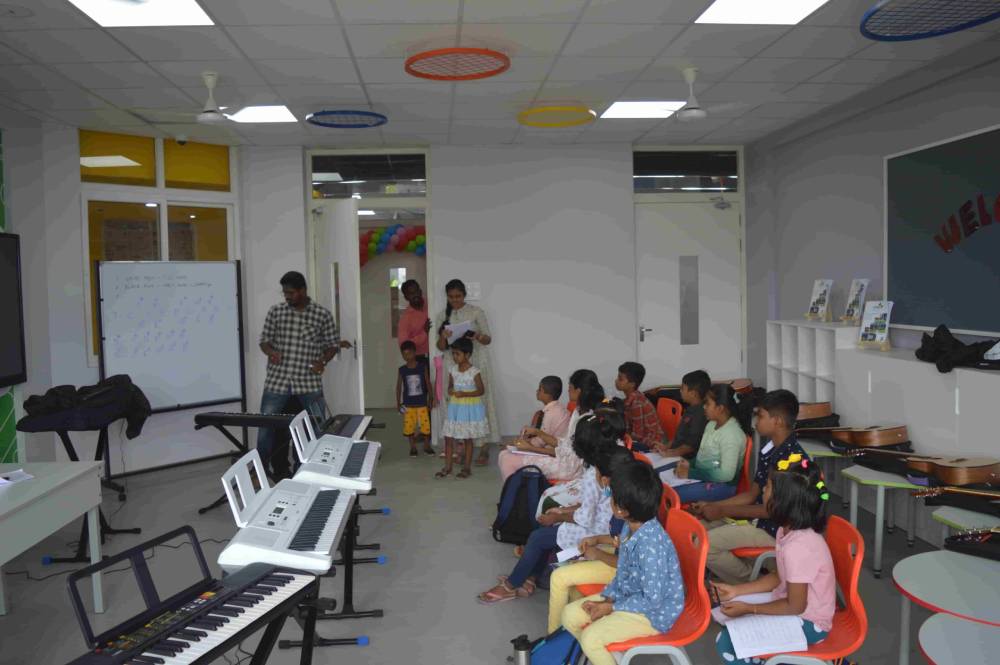 Students gathered in a keyboard class at CMIS.