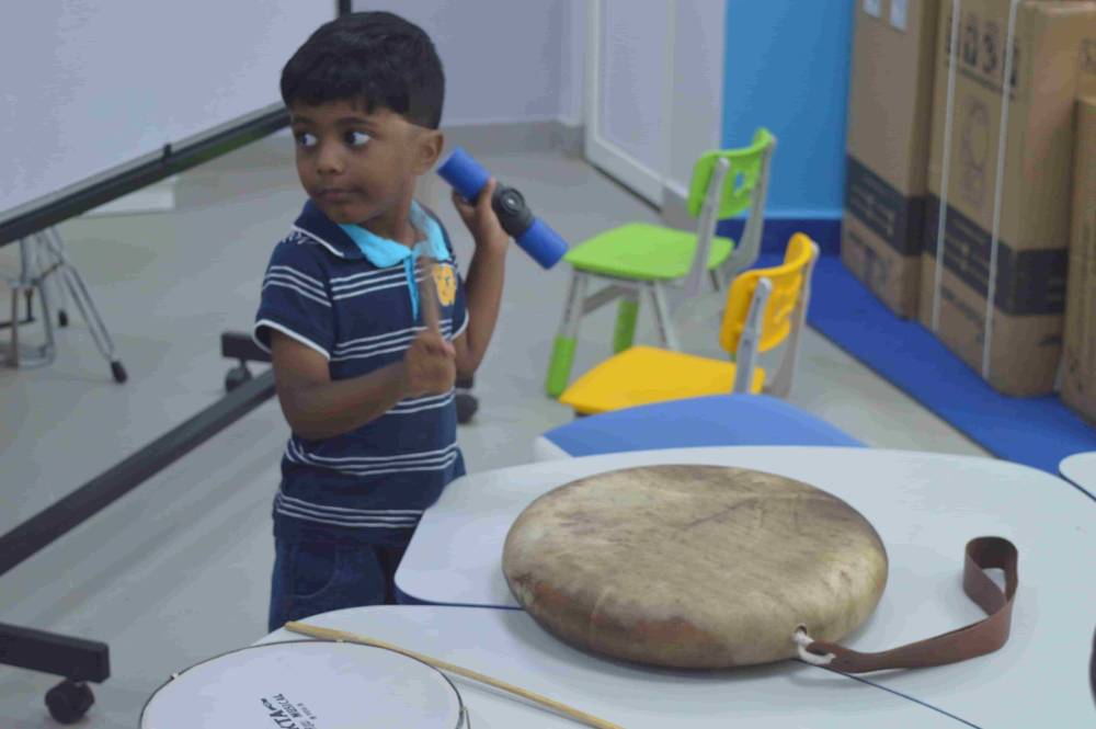 Small boy practising Tamil folk instrument.