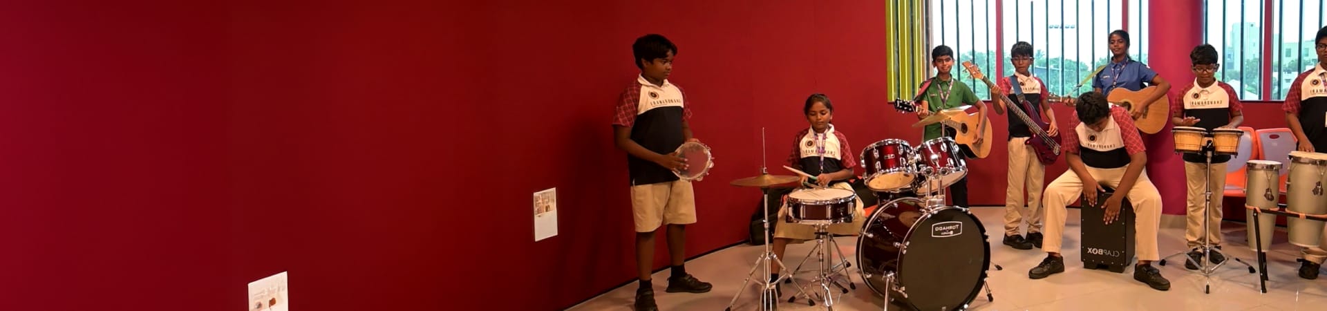 Engaged students in CMIS Music Department playing instruments together.