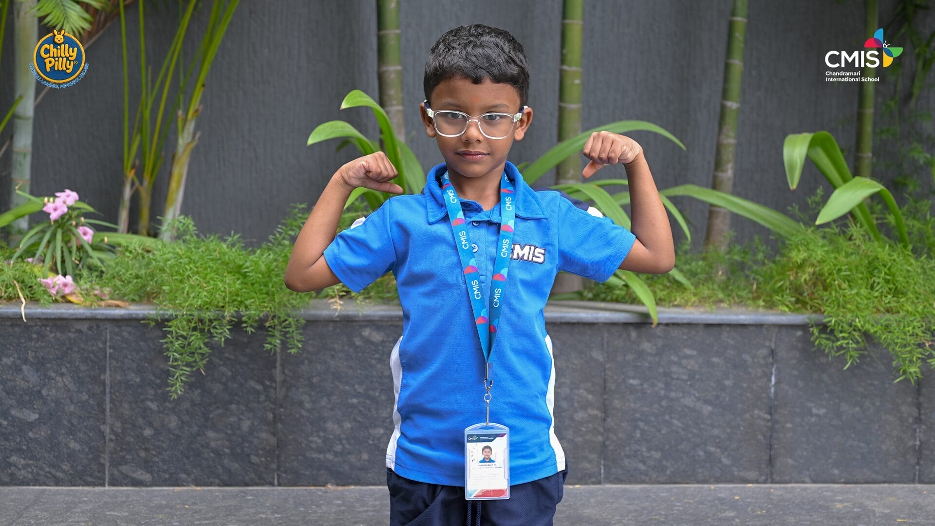 CMIS School student proudly shows strength in Activity Corner event.