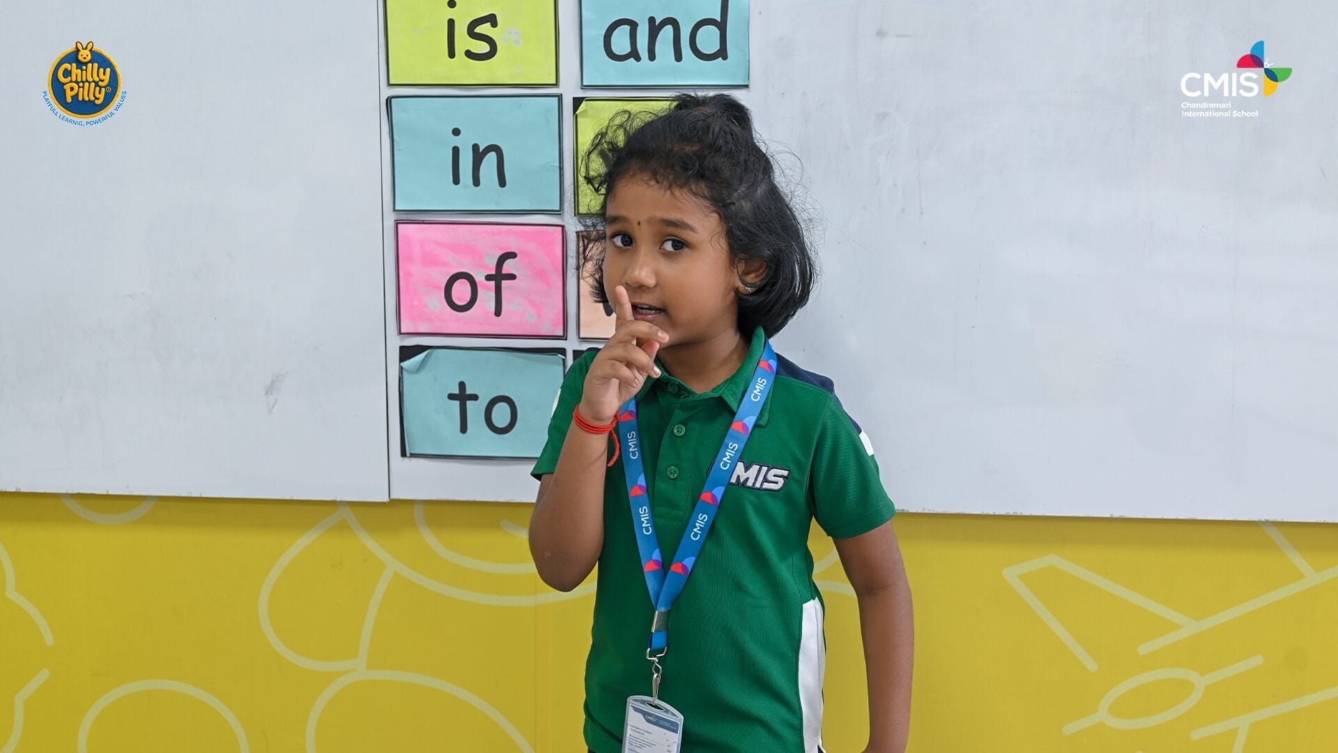 CMIS School student proudly shows strength in Activity Corner event.