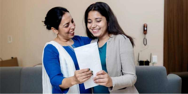 Indian mother and daughter celebrating CBSE Class 11 admission after receiving school admission letter.